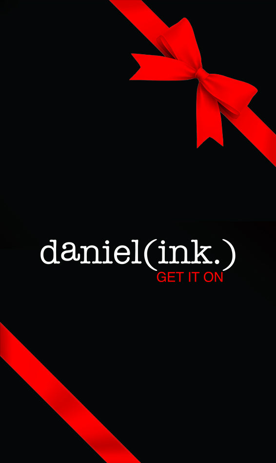 Black card with red ribbon wrapped around it and a red bow in the top right corner. The daniel(ink.) logo in white and red is in the centre of the card.