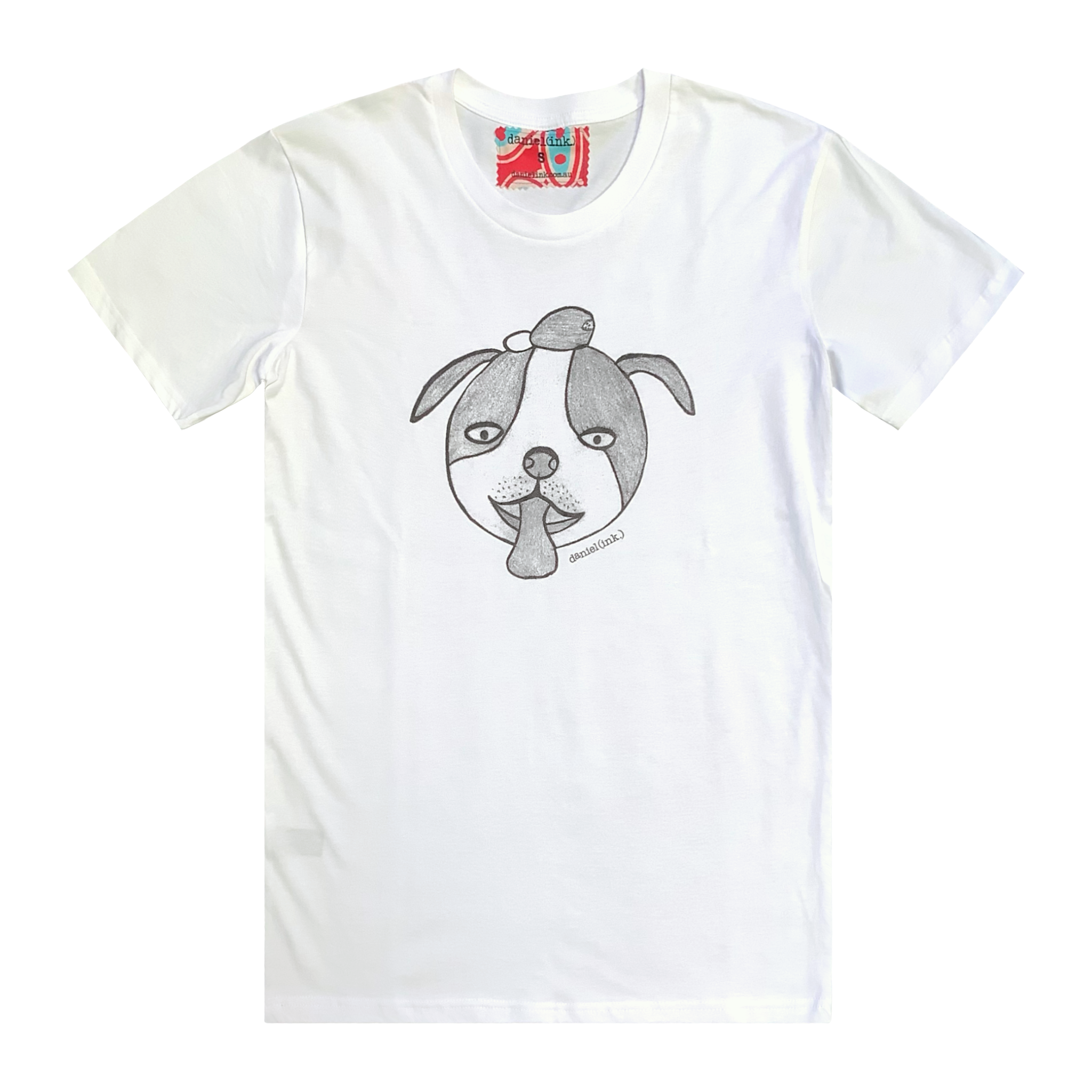 White short sleeve men's t-shirt featuring a hand drawn sketch of a dog’s face in black. The dog has a round head, floppy ears, wide eyes, and its tongue is sticking out. The t-shirt has a red, white, and blue fabric label on the back of the neck.