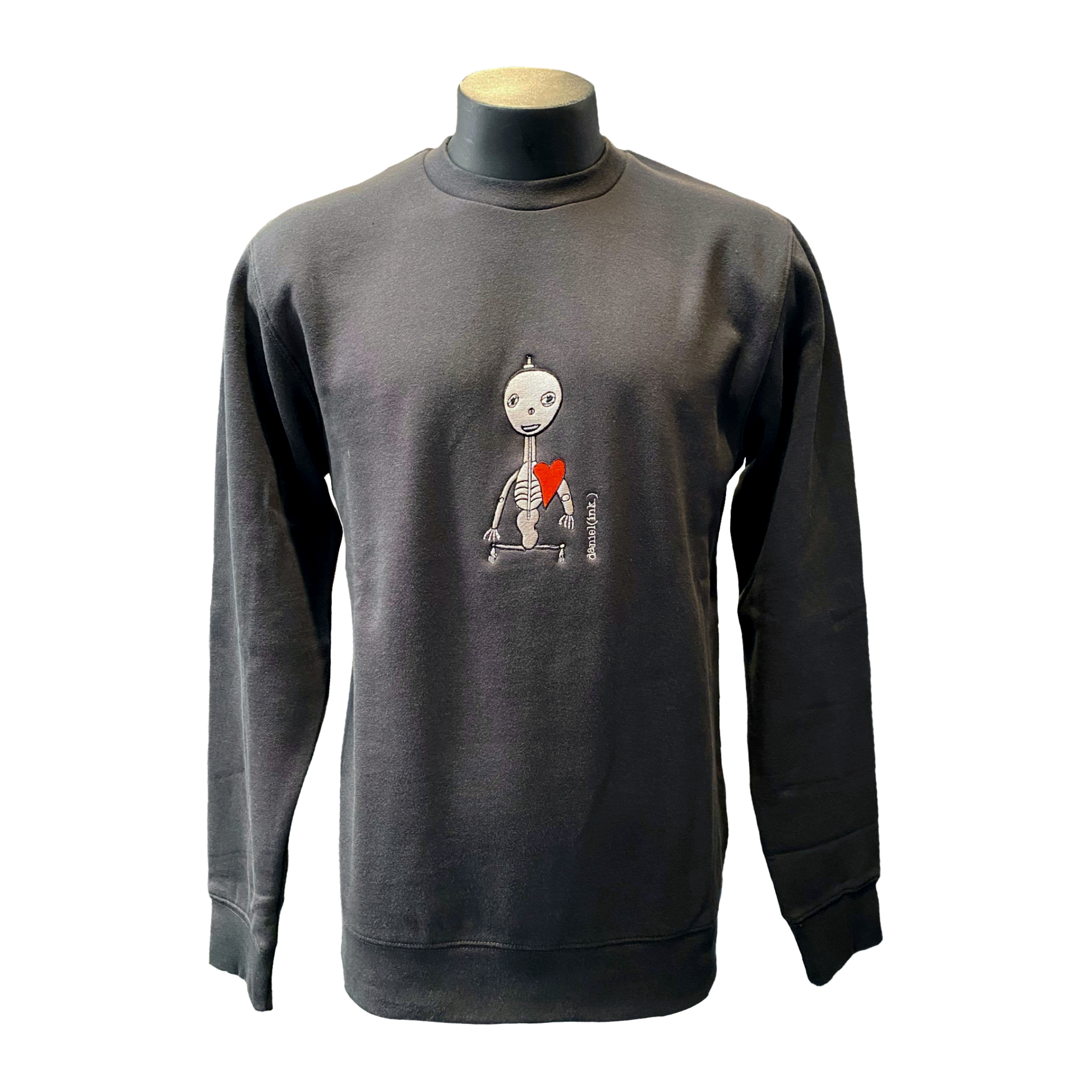 Unisex coal crew jumper featuring an embroidered image of a silver skeleton with a red heart. The name daniel(ink.) is embroidered in silver thread next to the skeleton.