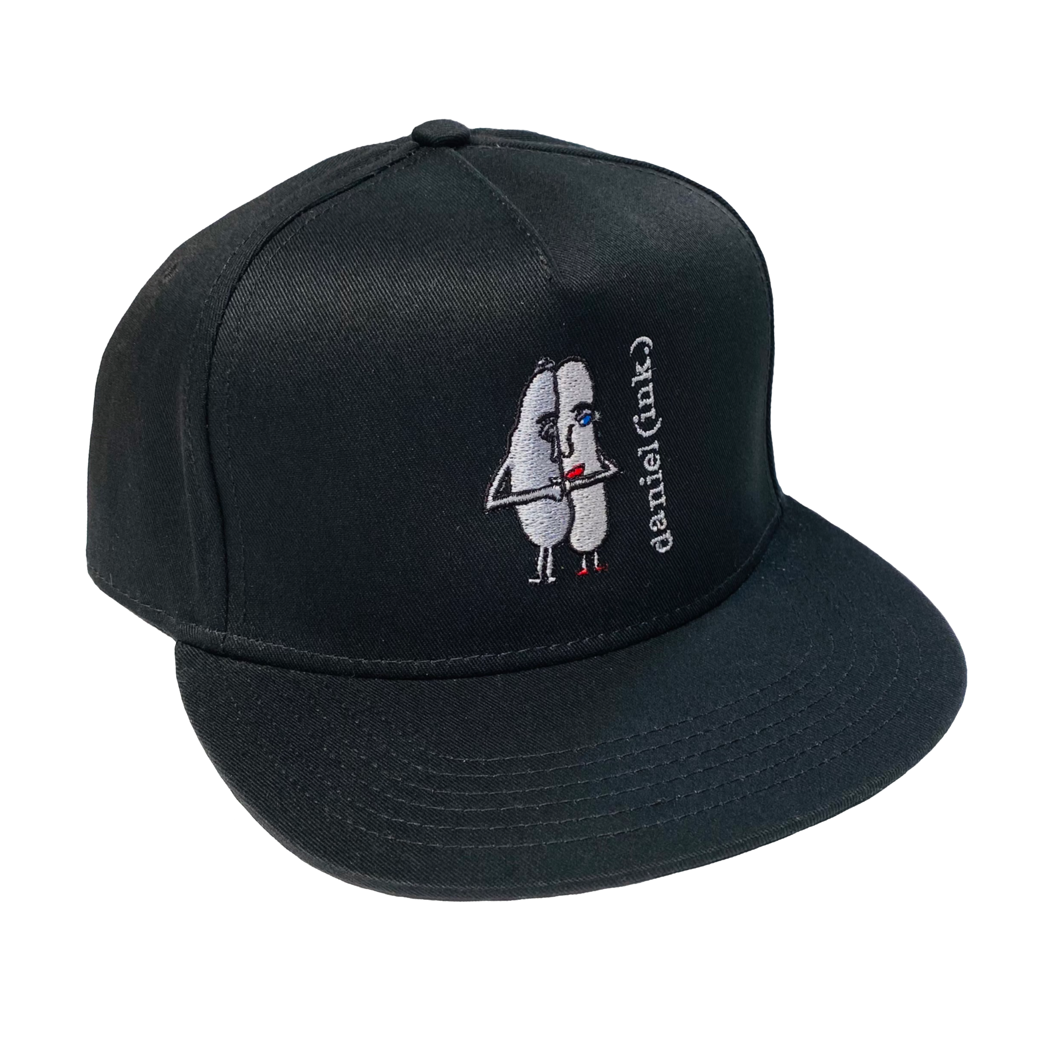 Black snapback cap featuring an embroidered image of two oval-shaped humanoid figures merged side by side and holding hands in silver. The humanoid figure on the left is wearing a bowler hat and the humanoid figure on the right has red lips. The name daniel(ink.) is embroidered in silver thread next to the oval-shaped humanoid figures.