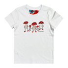 White kids' t-shirt featuring a hand drawn image of five humanoid mushroom figures, three large and two small, standing next to each other. Each mushroom figure has a red mushroom cap, red shoes, and red accents. The three large mushrooms also have red buttons on their chests which spell "magic" in Morse code. This t-shirt has a red, white, and blue fabric label on the back of the neck.